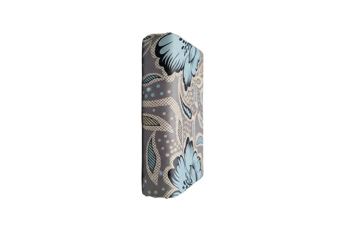 Floral pattern in light blue, beige, and black, shown against a plain white background.
