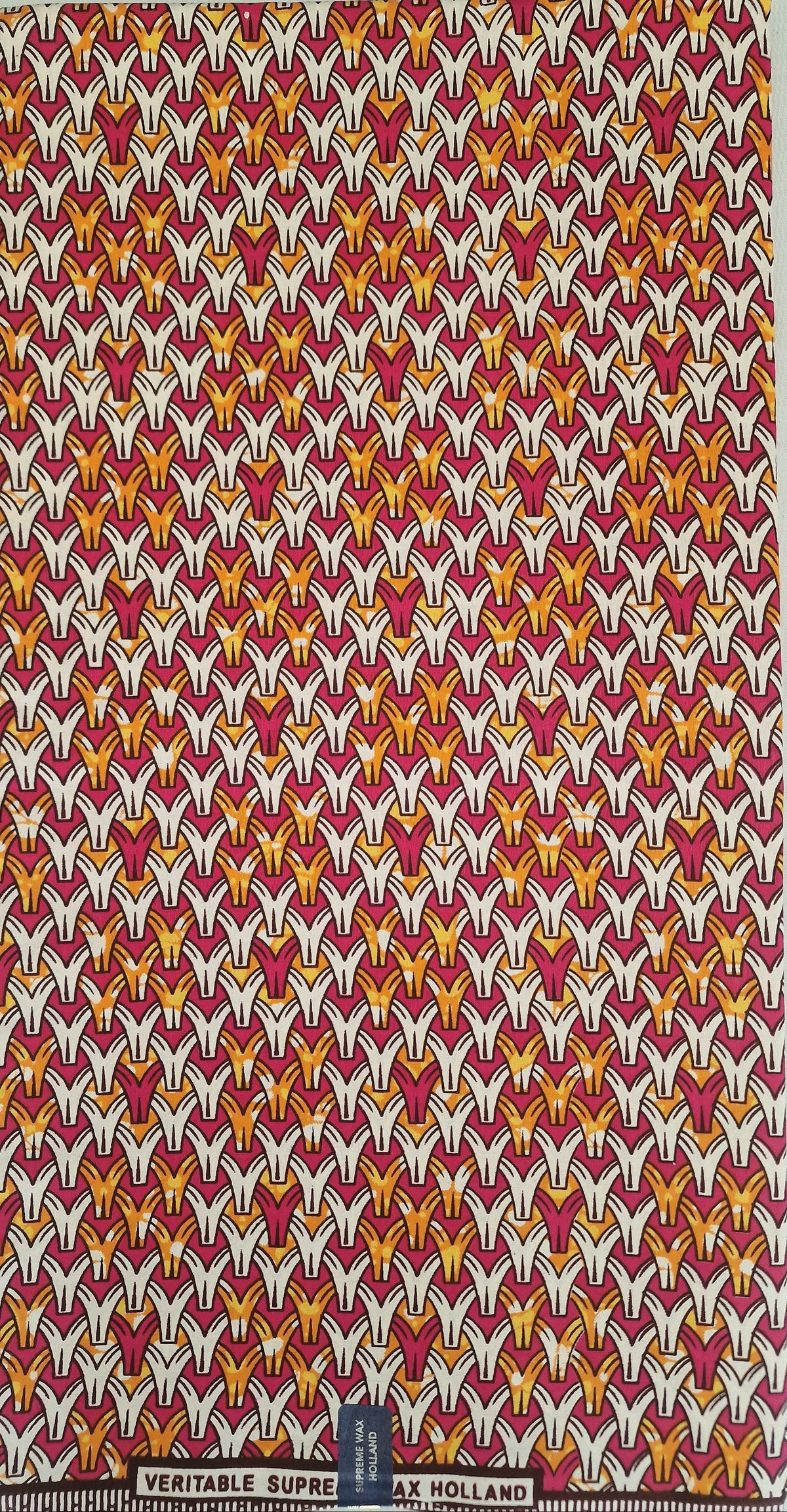 100% Cotton African wax fabric with a dense, repeating geometric pattern of stylized birds in white, yellow, and orange on a deep red background.