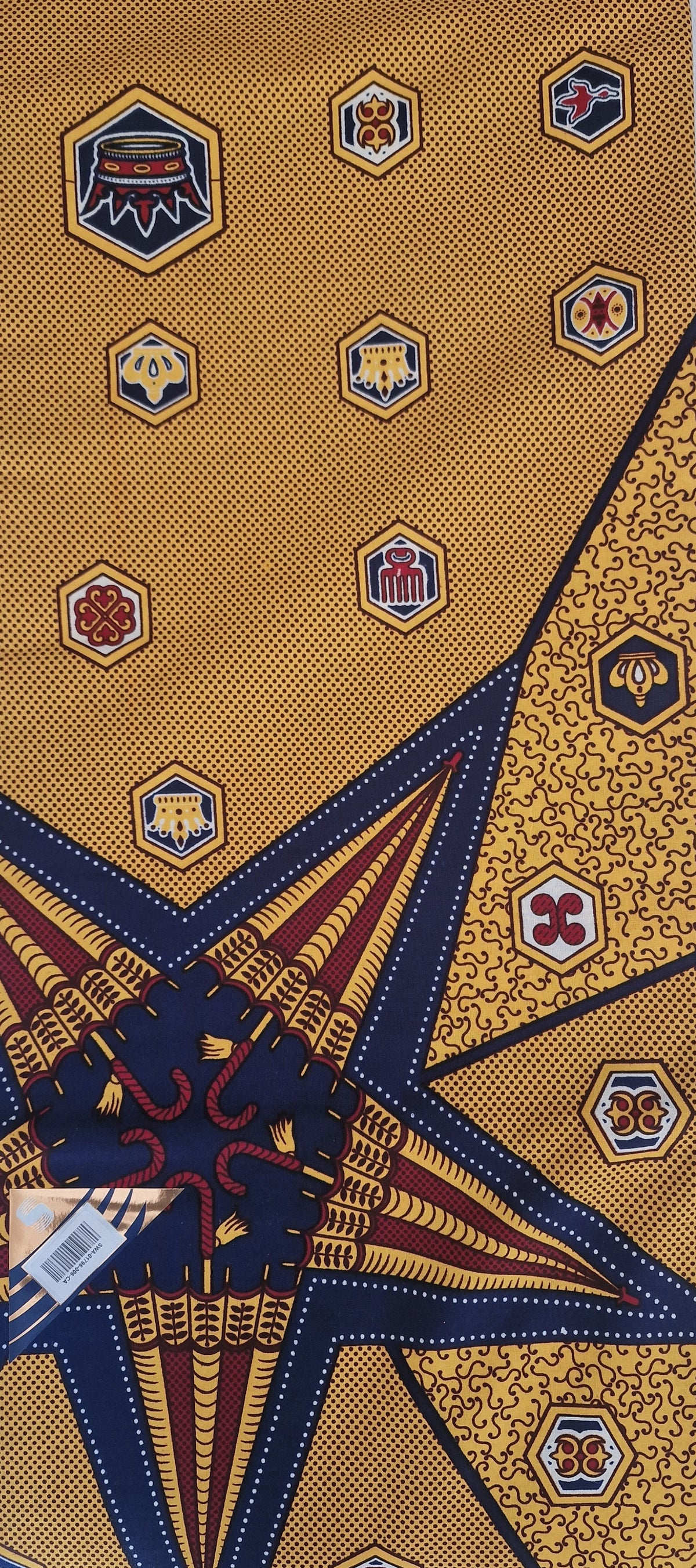 Yellow and navy blue patterned tie with geometric star and hexagonal motifs, laid flat on a white background.
