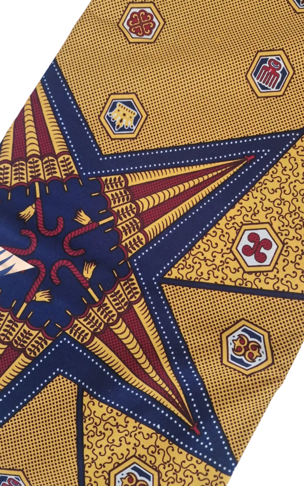  Patterned Ankara print featuring bold geometric and ornamental motifs in mustard yellow, white and dark brown