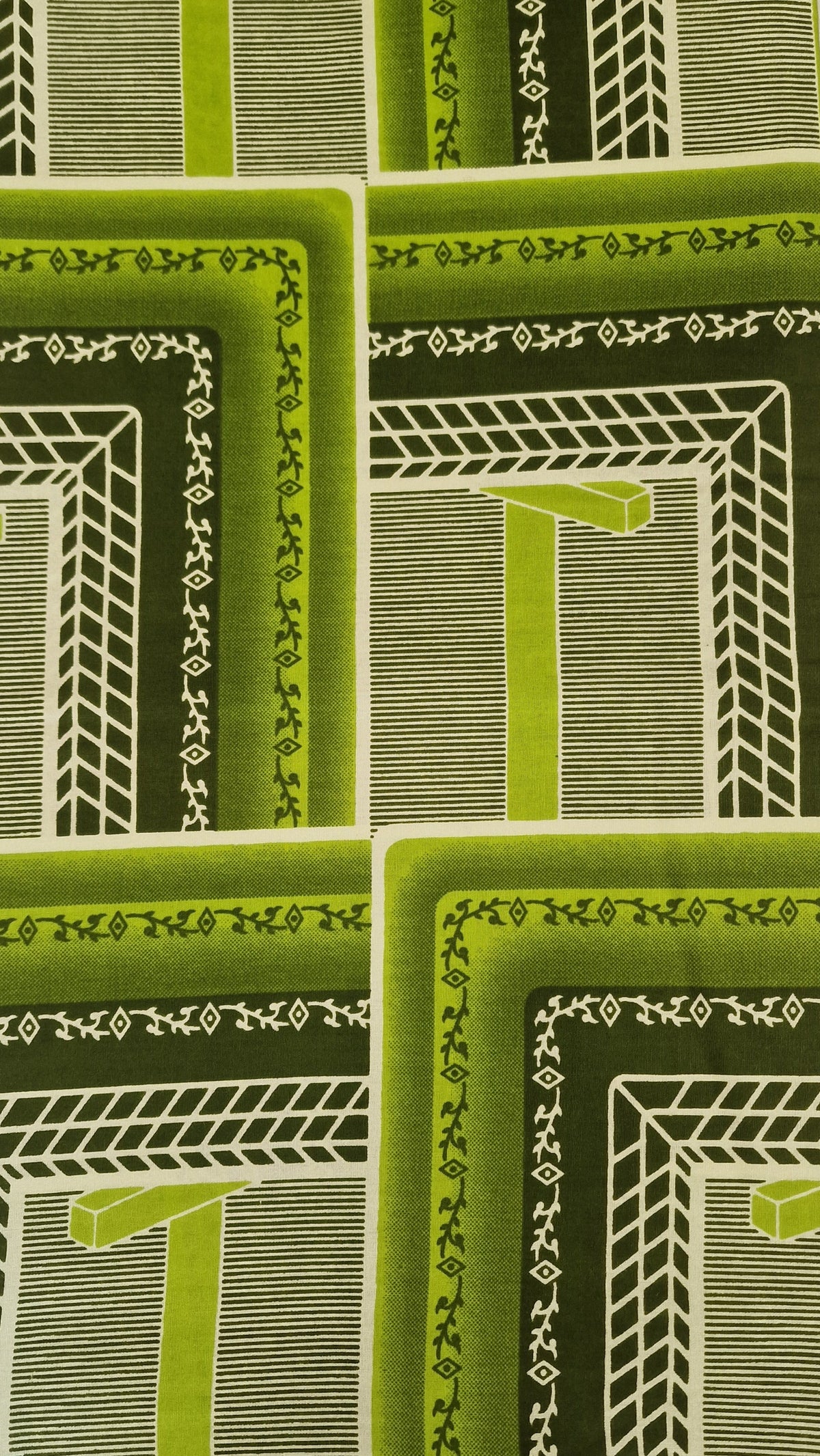 African Wax print featuring a retro geometric pattern in shades of green, olive, and white. The pattern consists of nested rectangular frames with striped and textured details