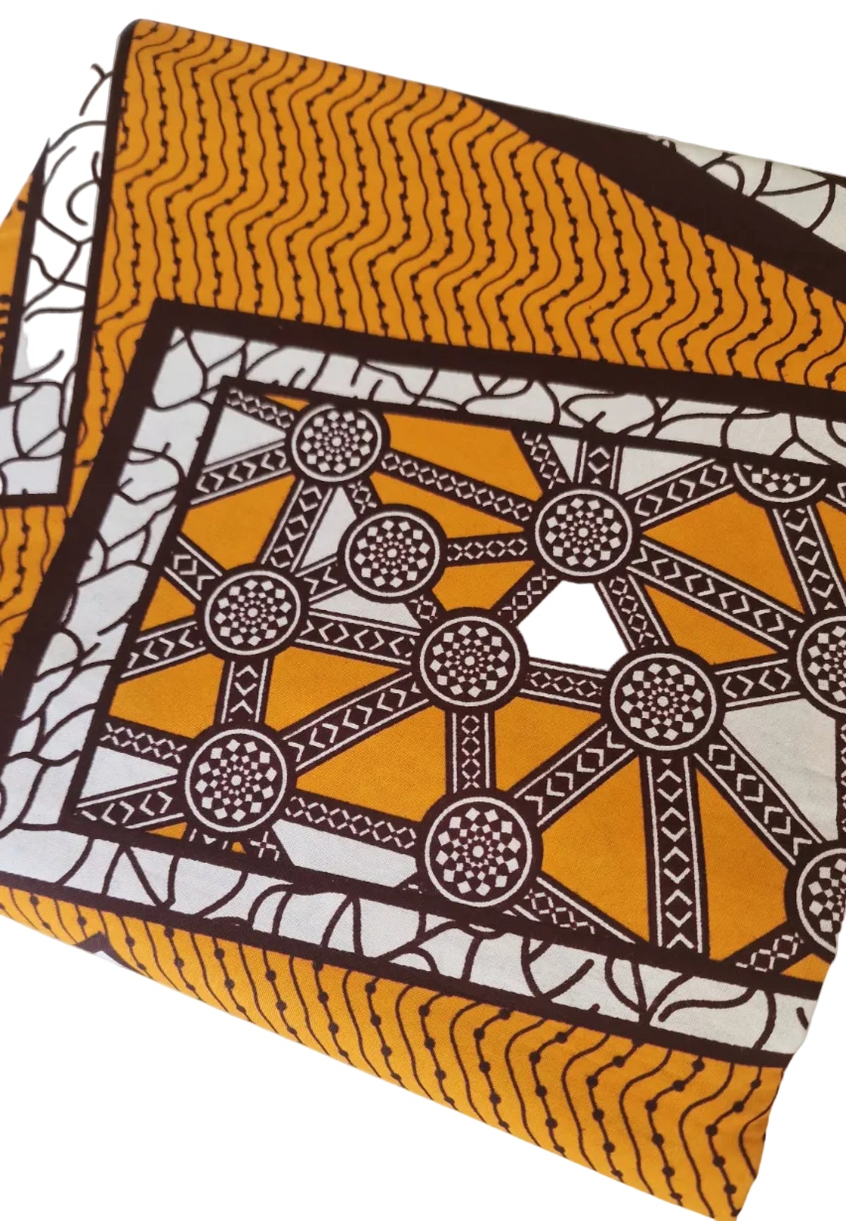 Patterned Ankara print featuring bold geometric and ornamental motifs in mustard yellow, white and dark brown