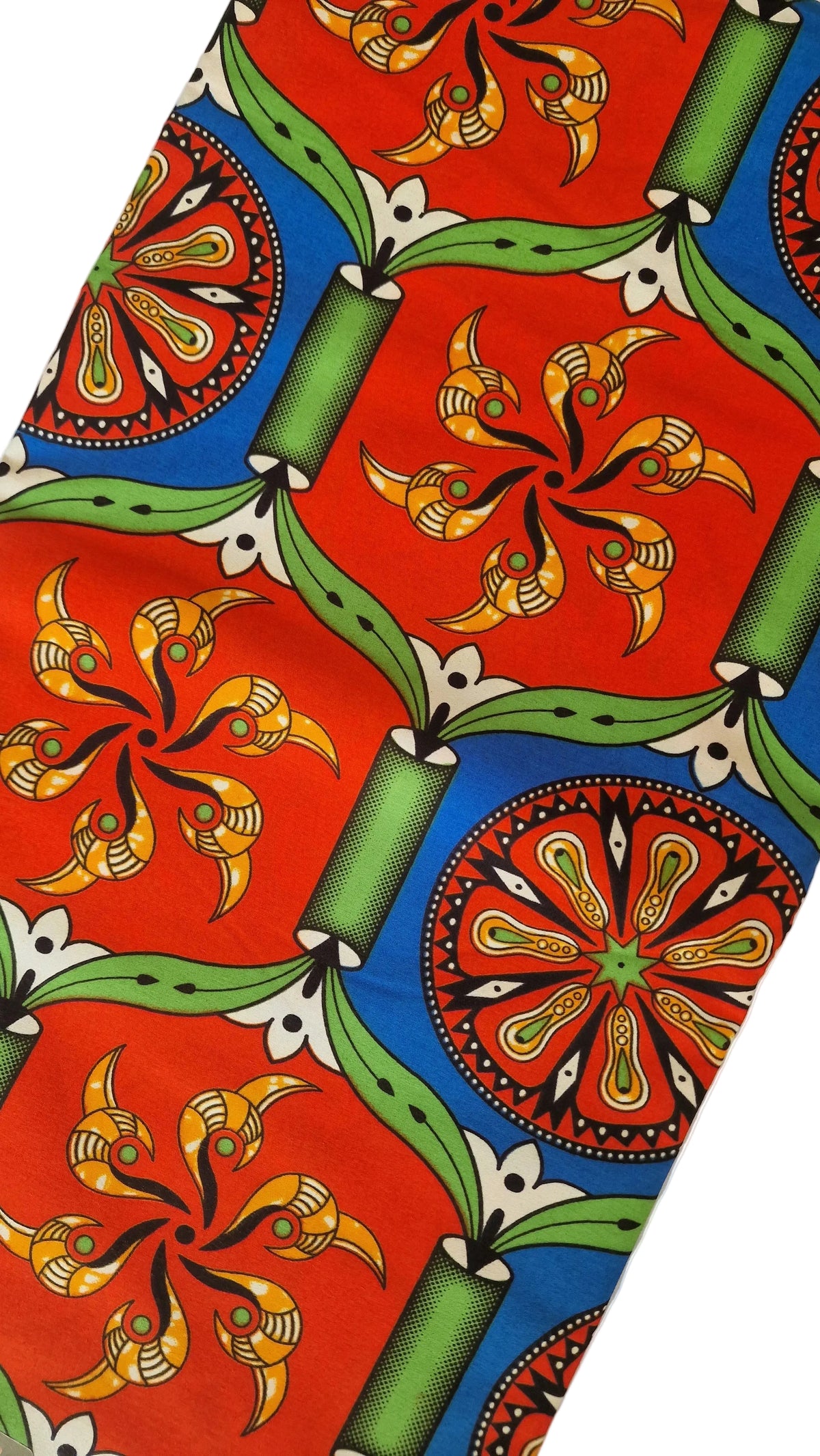 Traditional kola patterned African wax print fabric featuring vibrant red, blue, green, and yellow geometric designs and floral motifs.