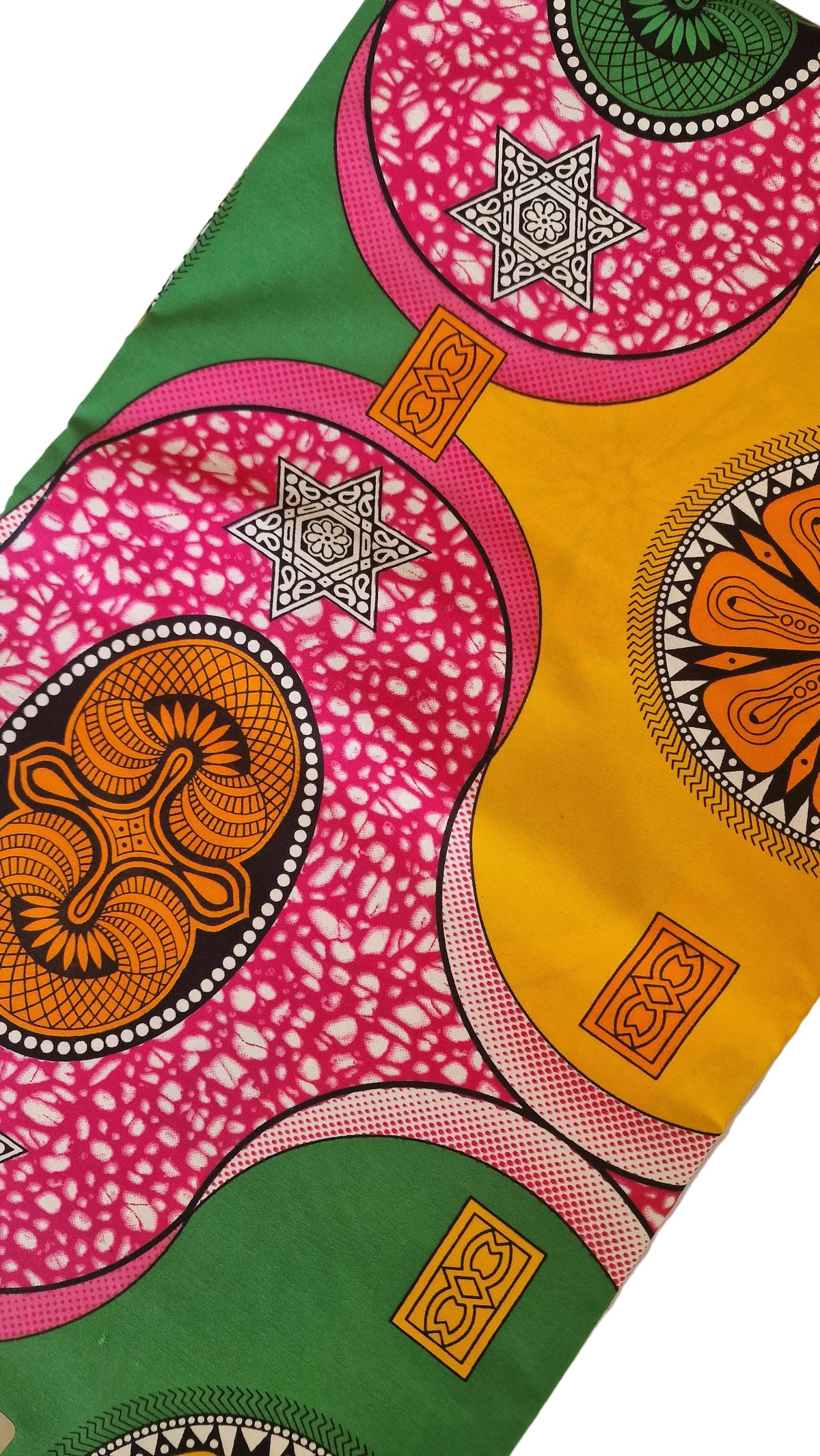 Bold African wax print pattern, featuring large overlapping circles and floral motifs in pink, yellow, green, orange, and black. 